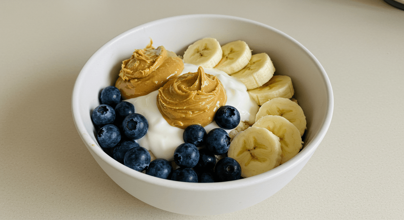 a bowl of yogurt blueberries bananas and peanut butter
